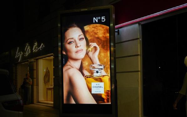 Front view of a store with a Chanel advertisement